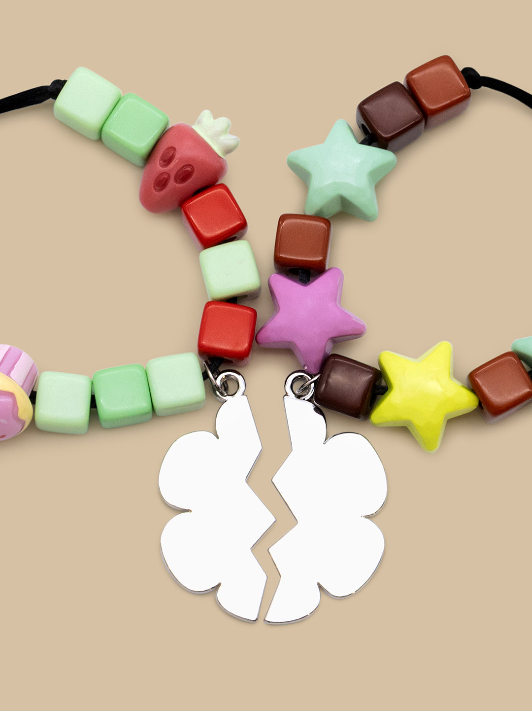 A set of two colorful beaded necklaces with broken four-pointed star pendants, displayed on a beige background. The necklaces feature pastel green, red, brown, light green, mint green, pink, yellow, and white beads.