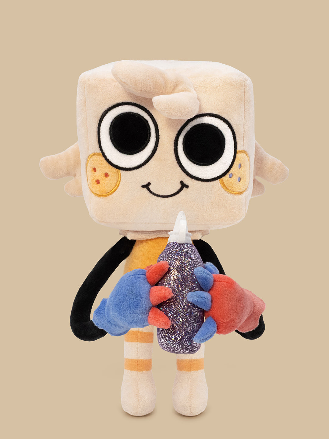 A plush toy character with a square cream head, large black-and-white eyes, a small smile, and colorful arms and legs. The character is holding a glittery purple bottle with blue, orange, and red gloved hands against a solid beige background.