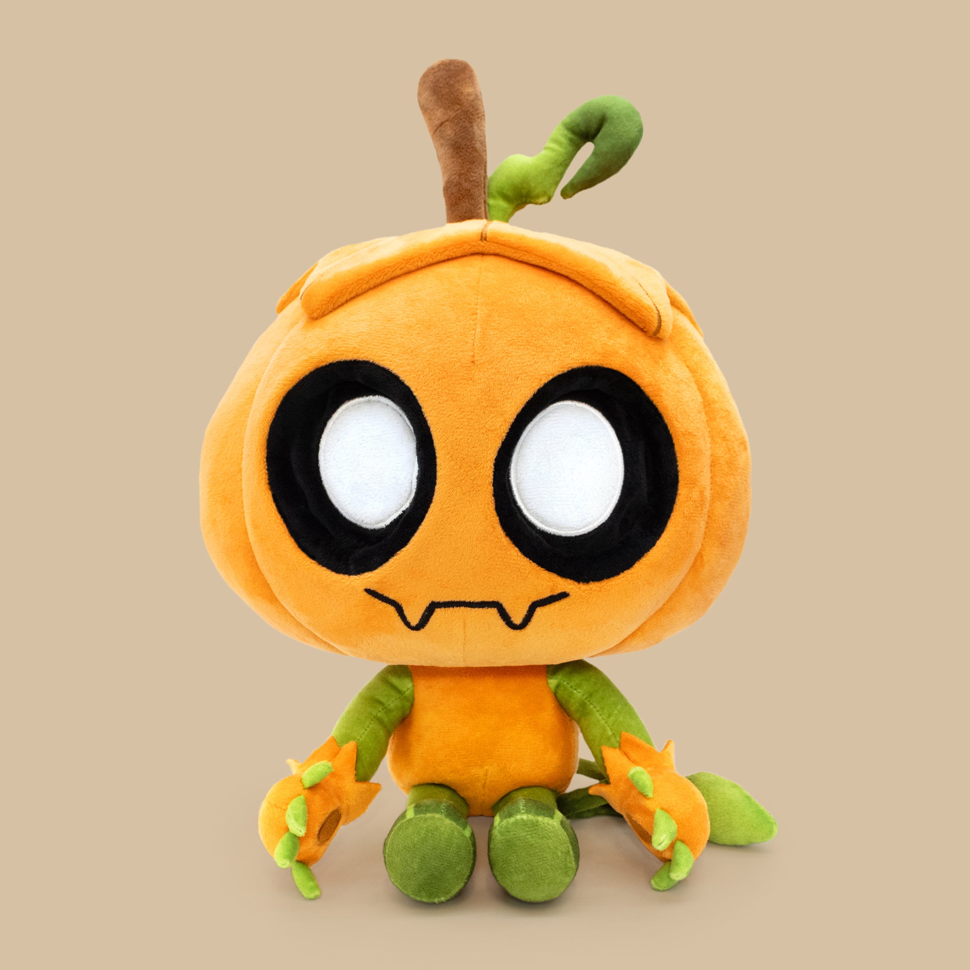 Plush toy resembling a cartoon character with an orange body and green limbs on a beige background