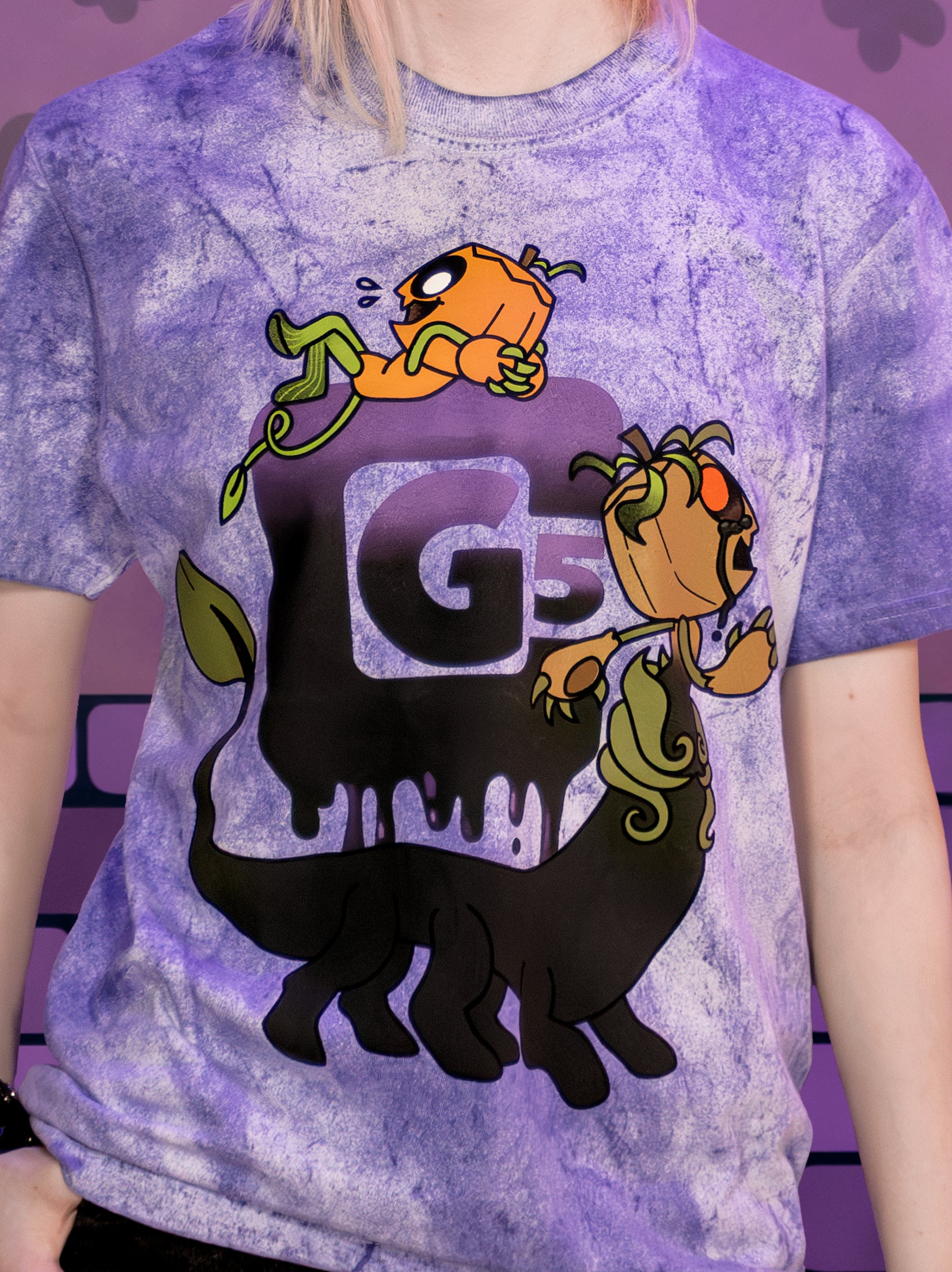 Person wearing a purple tie-dye t-shirt with cartoon characters and  'CG5'.