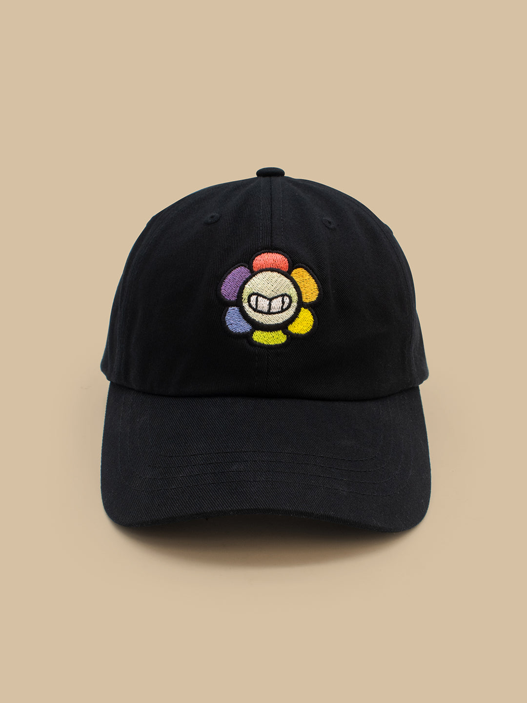 Black cap with a colorful embroidered logo on a beige background