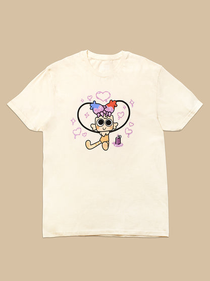 An off-white short-sleeve t-shirt with a colorful cartoon graphic of a character inside a heart, displayed flat against a solid beige background.