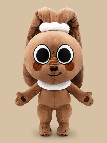 Brown plush toy with large eyes on a beige background