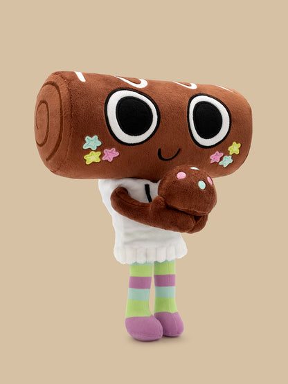 A plush toy character with a large brown log head, black-and-white eyes, a smiling face, colorful star accents, a white hoodie, and pastel striped legs, standing against a plain beige background.