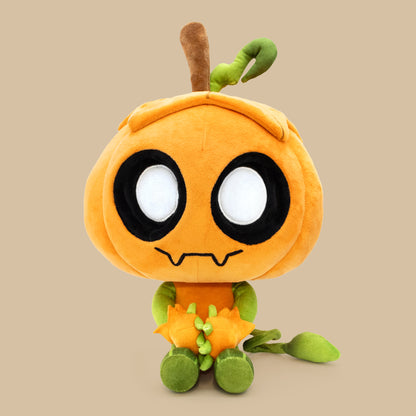 Plush toy resembling a cartoon character with an orange body, black eyes, and green limbs on a beige background