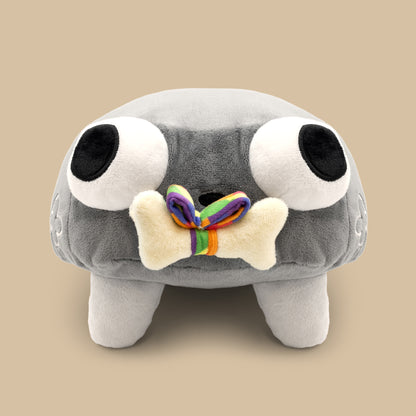 Gray plush toy with large eyes and a rainbow bone on a beige background