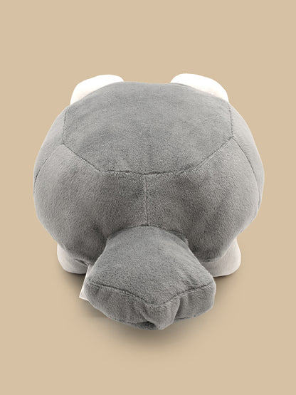 Gray plush toy resembling a turtle on a beige background