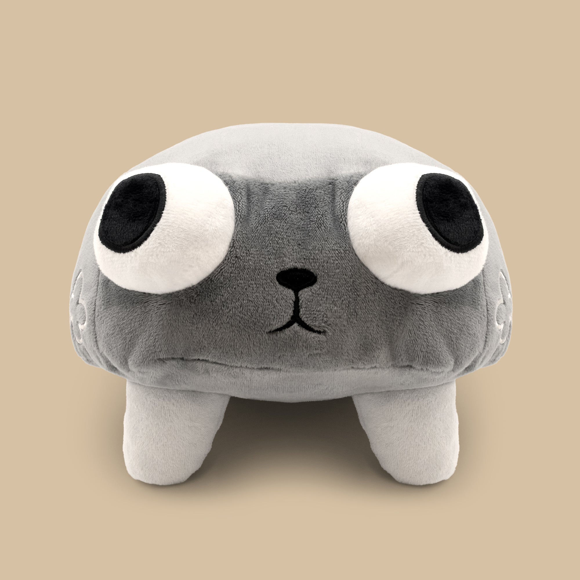 Plush toy with a gray body, black eyes, and a small black nose on a beige background