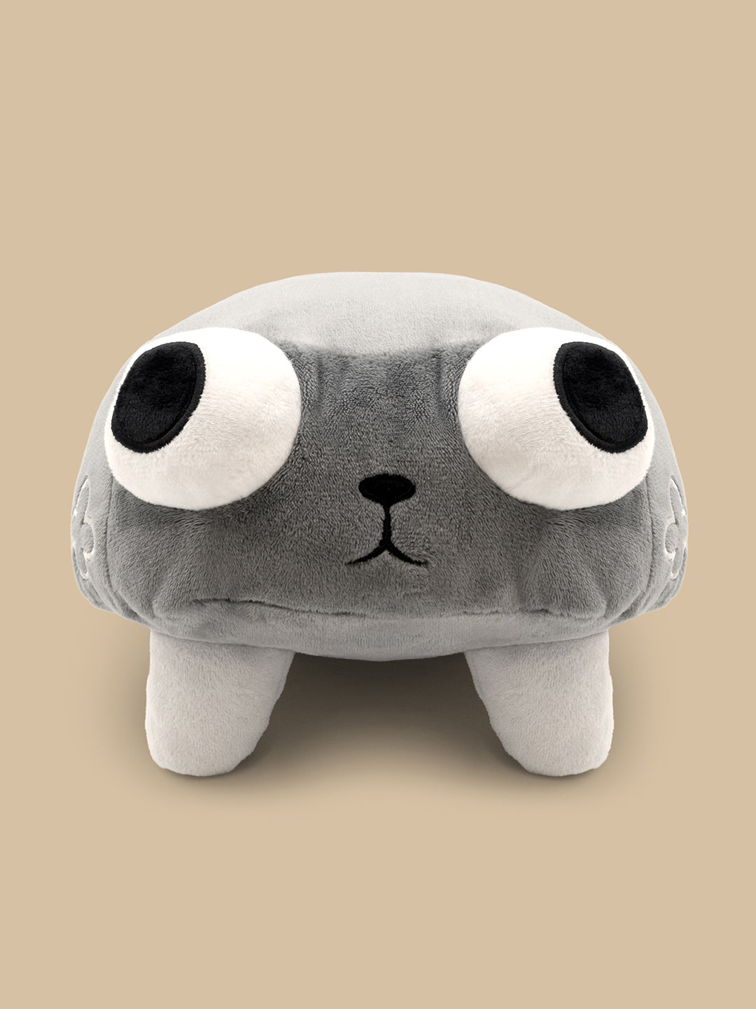 Plush toy with a gray body, black eyes, and a small black nose on a beige background