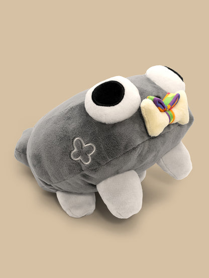 Gray plush toy with a bow on a beige background