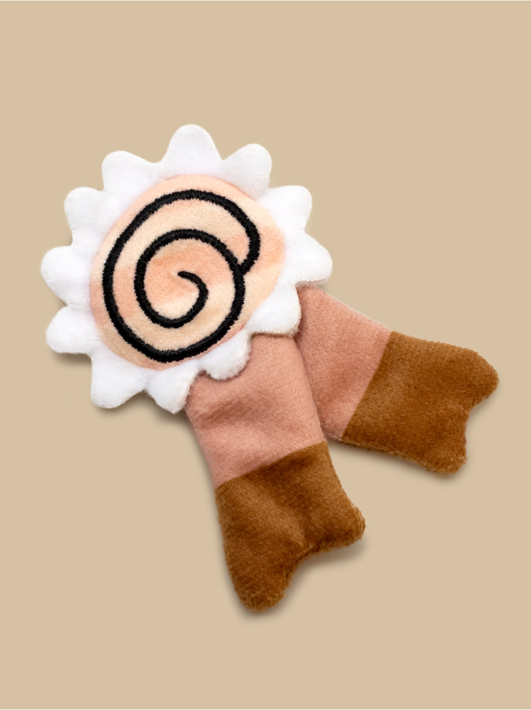 Felted toy with a spiral design on a beige background