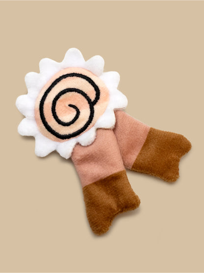 Felted toy with a spiral design on a beige background