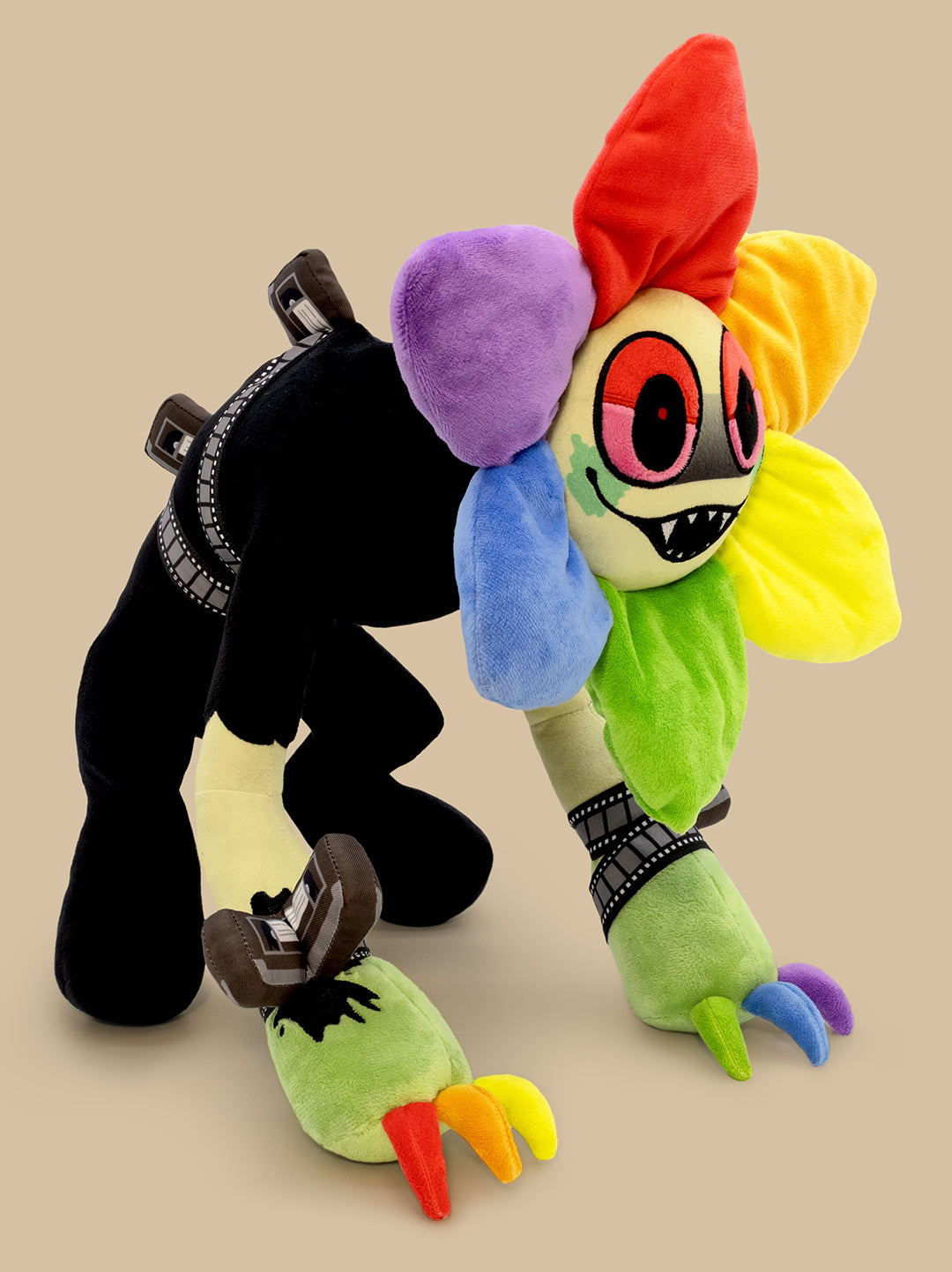 Colorful plush toy with a black and white character on a beige background