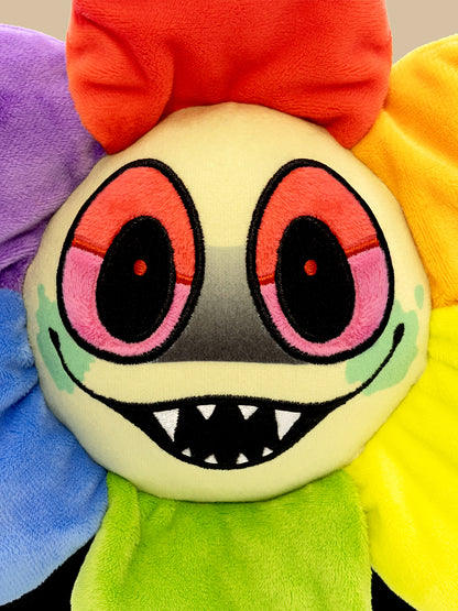 Colorful plush toy with a smiling face and multicolored body