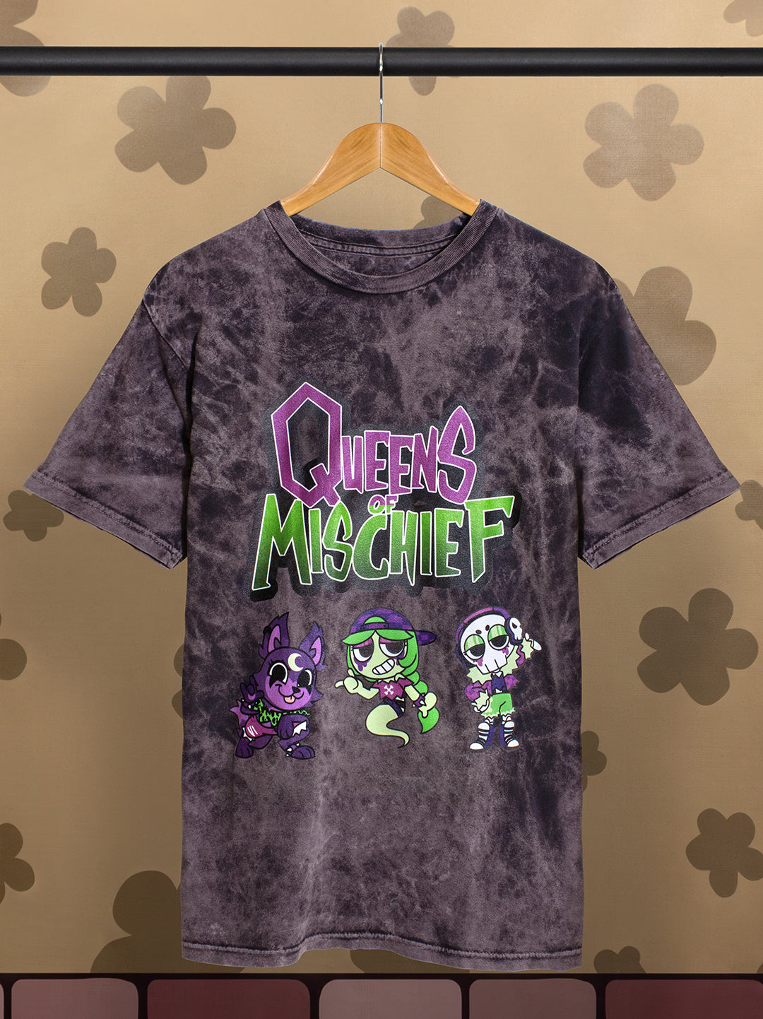 dark cloudy black shirt with image: queens of mischief text. eclipse, connie, and ribecca. shirt on hanger