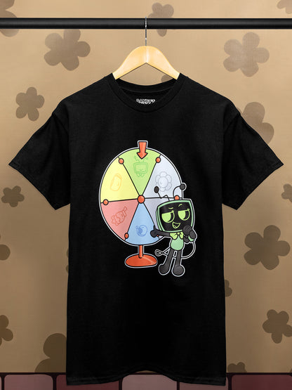 Black t-shirt with a colorful graphic design on a hanger against a patterned wall.